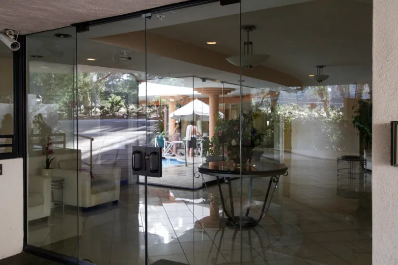 The glass doors leading into 450 N Maple Dr in Beverly Hills