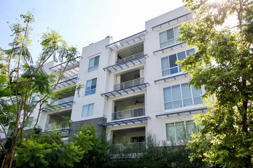 The sun lit balconies and trees at Palm Condominiums in Beverly Hills.