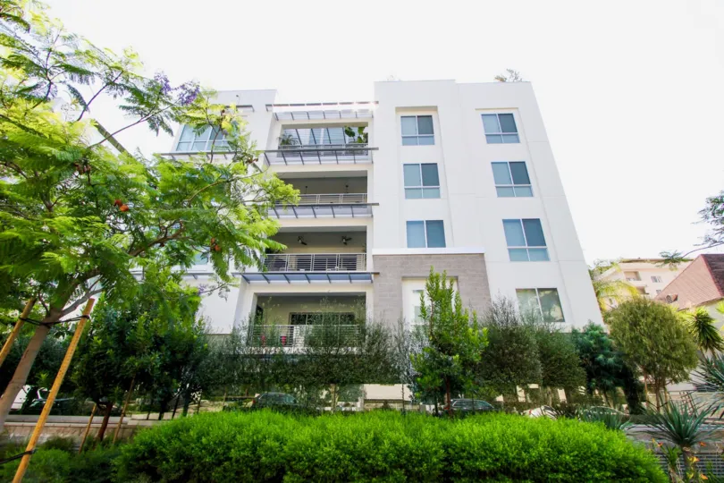 A view of the Palm Condominiums and the greenery outside.