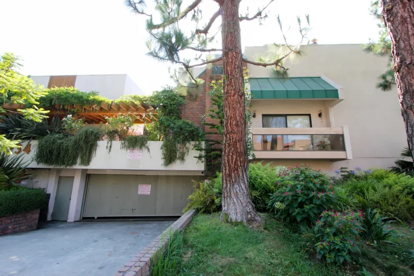 A sunny day in the lush landscaping of Tower Park with views of the balcony, trees and various plants