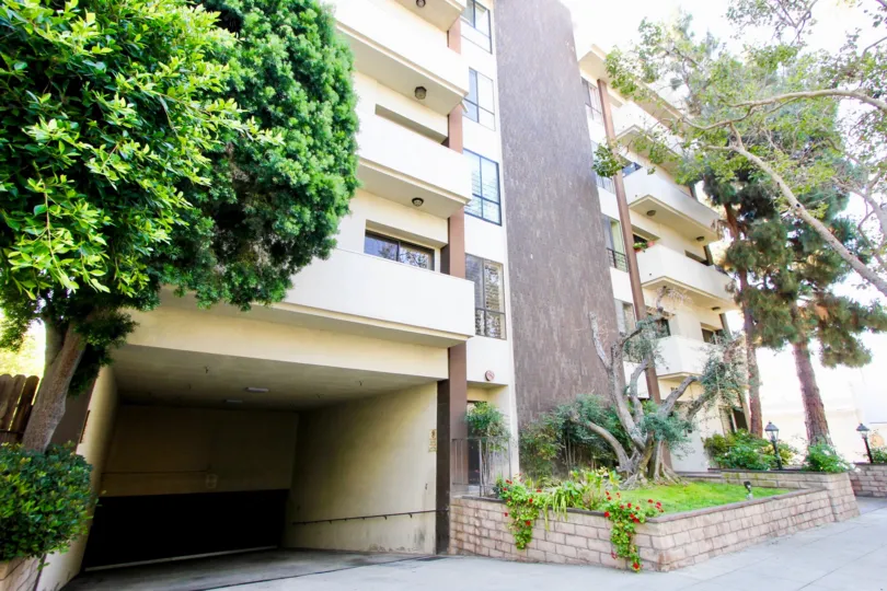 a building in wilshire swall with trees in the front in a sunny day