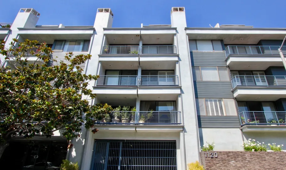 Four story Stucco Apartments with balconies at 1120 Granville in Brentwood California