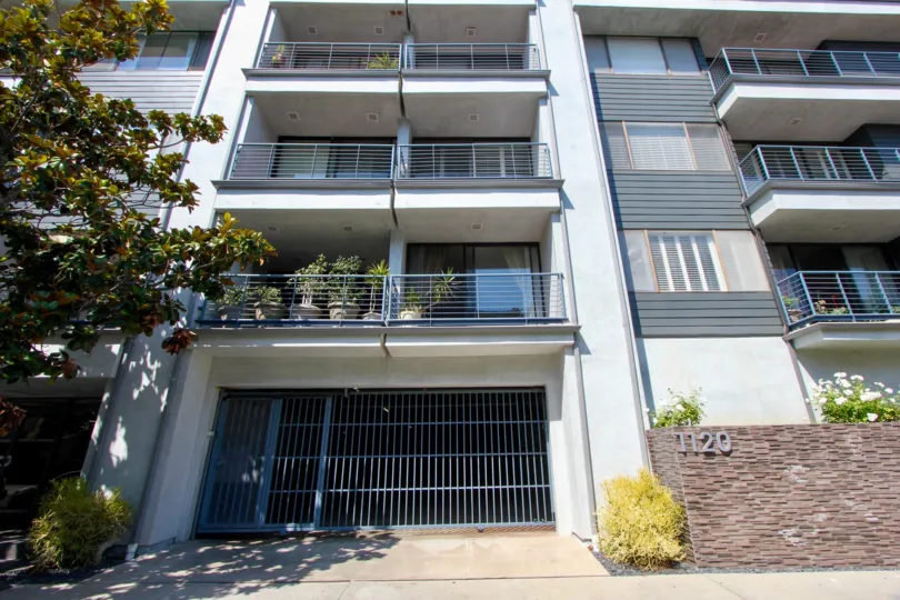The garages and upper story windows of the apartment building at 1120 Granville in Brentwood, California