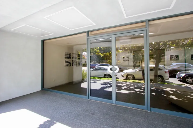 Cars in front of a glass door in 1120 Granville at sunny day