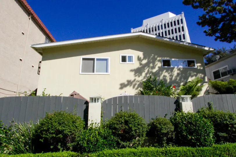 The 11634 Gorham condos sit behind a wood fence