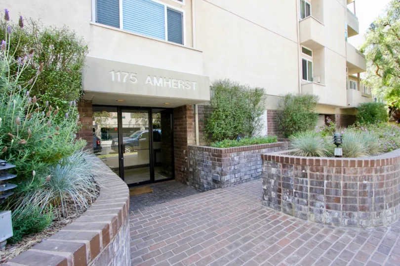 entry with plants and glass door in a large building in California