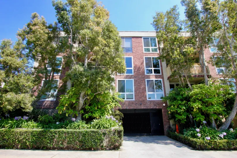 A large brick building surrounded by greenery in Brentwood, California
