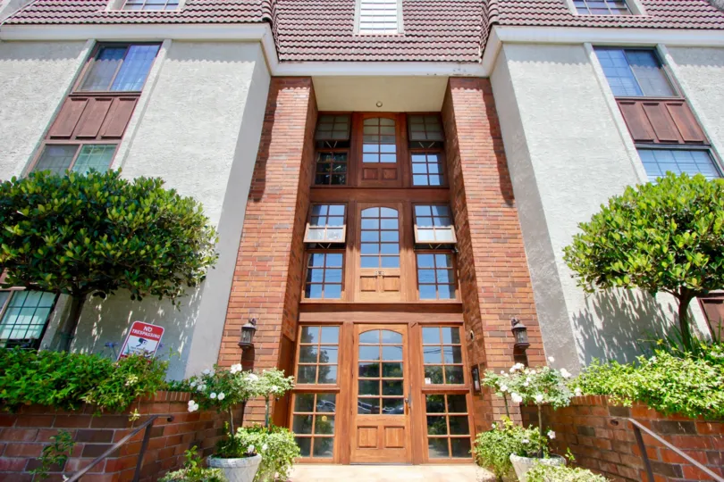 Daytime view of wooden doors and windows in Brentwood Pines California
