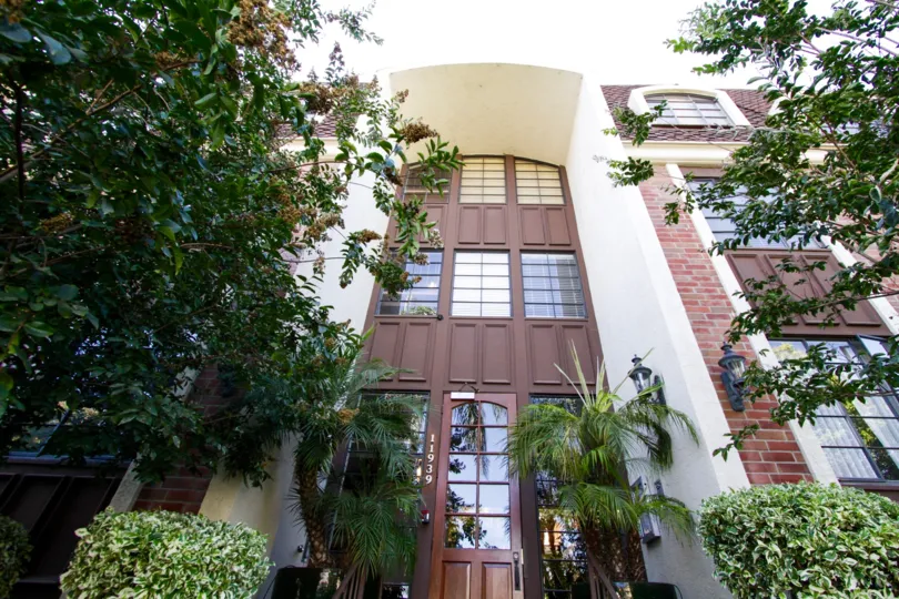 The entry to Brentwood Place is three stories tall with an arch at its height