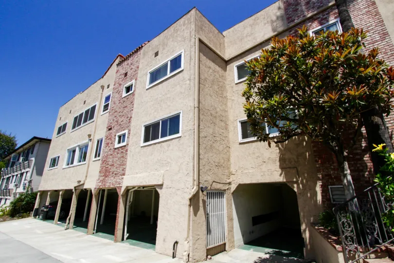 The exterior of Brentwood Plaza is stucco with red brick accents