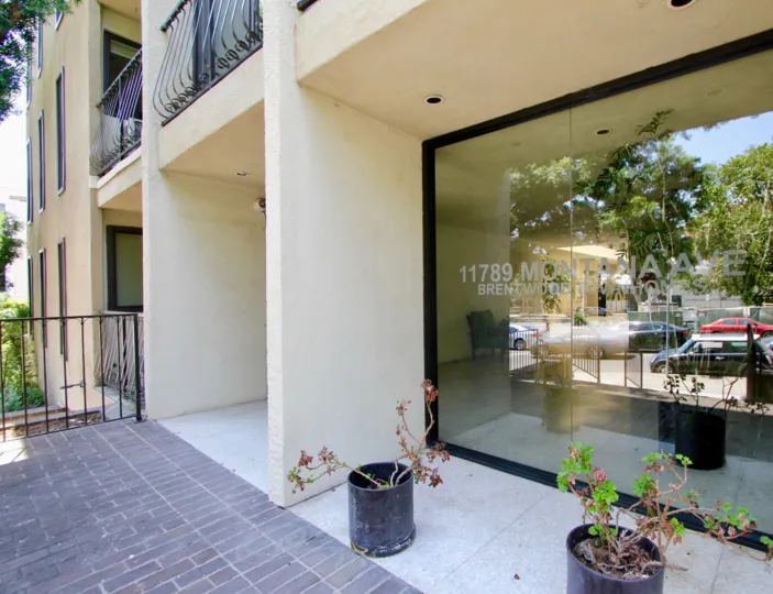 the front part of a building in Brentwood Townhomes, with a big glass view