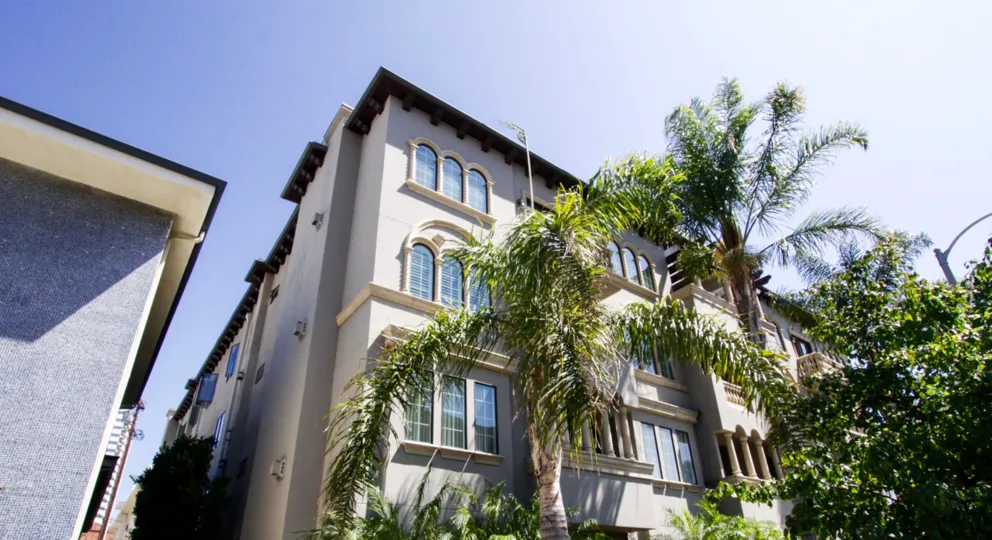 The front of Casa Bella Villas is well landscaped with tall palm trees