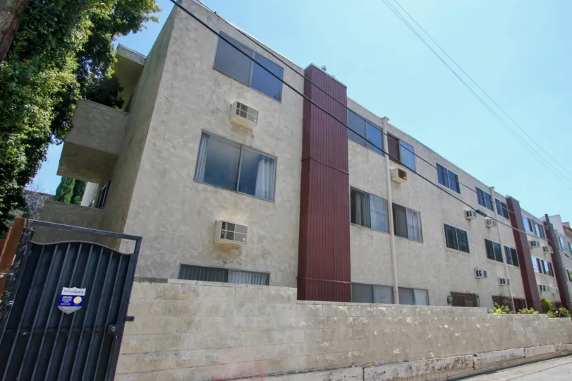 Air conditions stick out underneath the windows of an apartment complex in Casa Real.