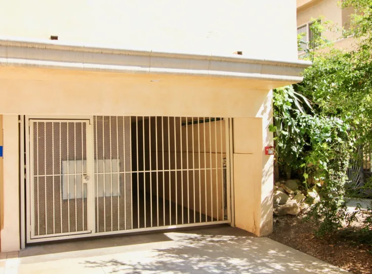 Entrance to a garage at Chateau Corham in Brentwood. Has a metal gate and locked door.