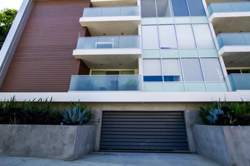 A garage door entrance off the side of the Chenault Flats building