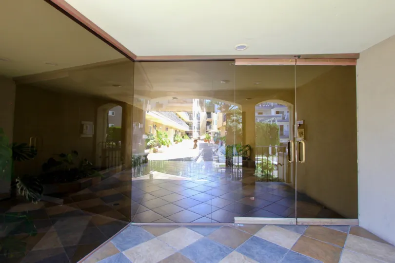 Sun reflecting on the tiles and glass of the entrance to Chenault Villas in Brentwood, CA