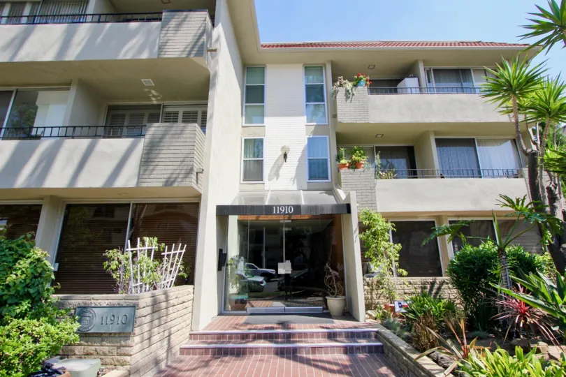 An apartment entrance at the Mayfield Manor on a sunny day in Brentwood, CA