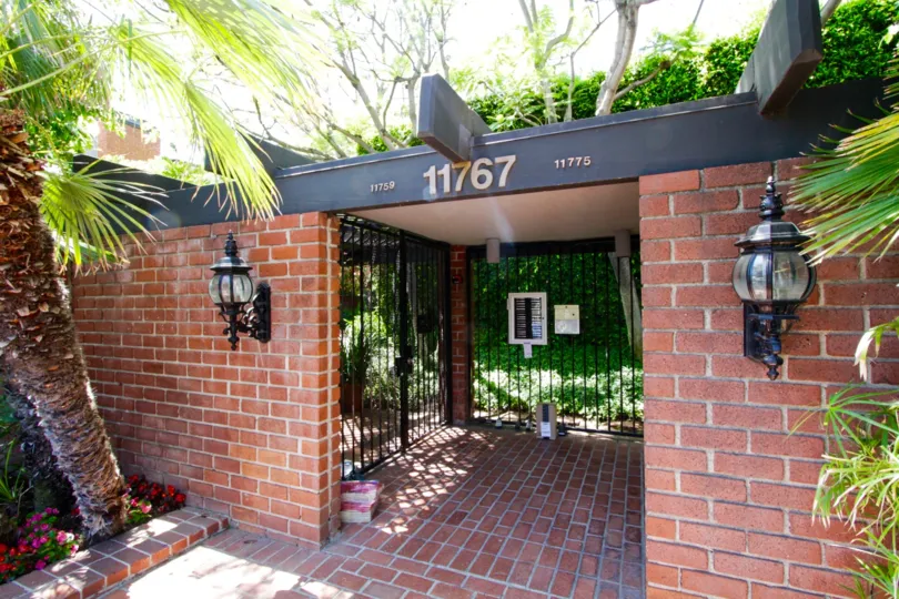 Red brick covers the entrance gate to Sunset Colony