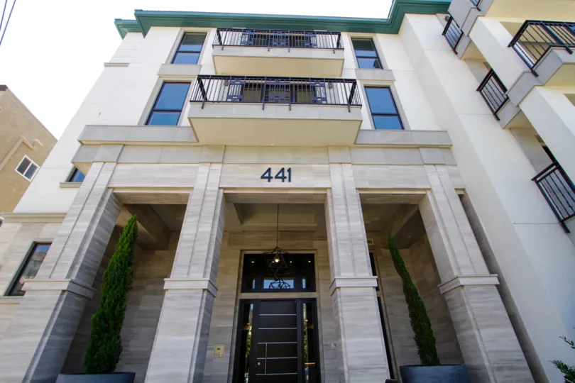 A geometric pendant hangs above the Cosmopolitan Brentwood entrance