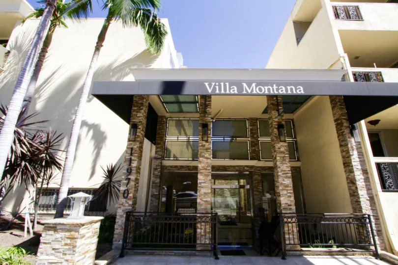 Large stone pillars rise to form the Villa Montana condo entry