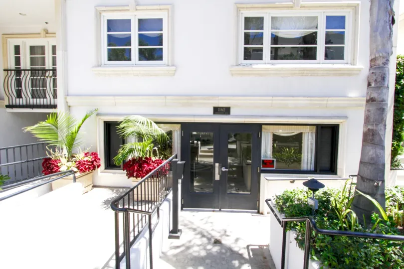 Stairs lead down to the front entrance of Villa Trocadero condos