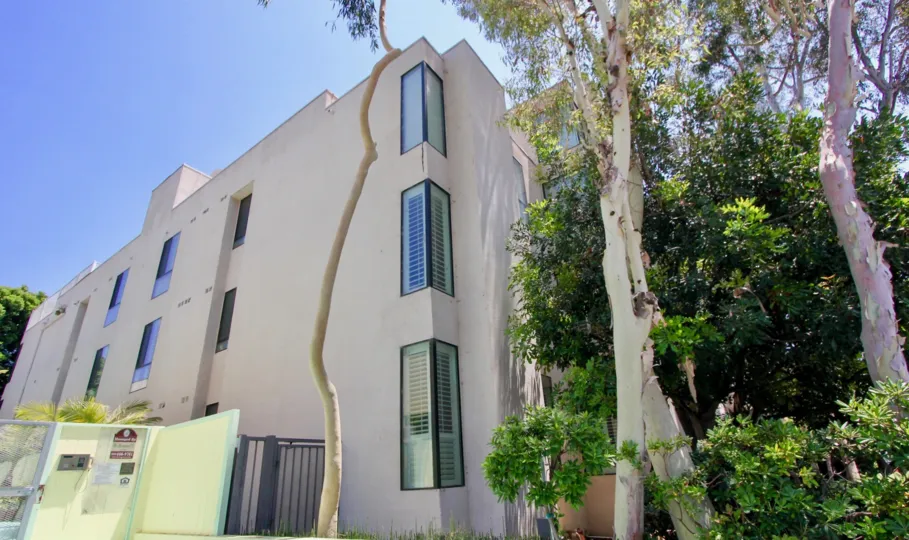 A sunny day for the residents of VIP Barrington, with trees surrounding the three story building.