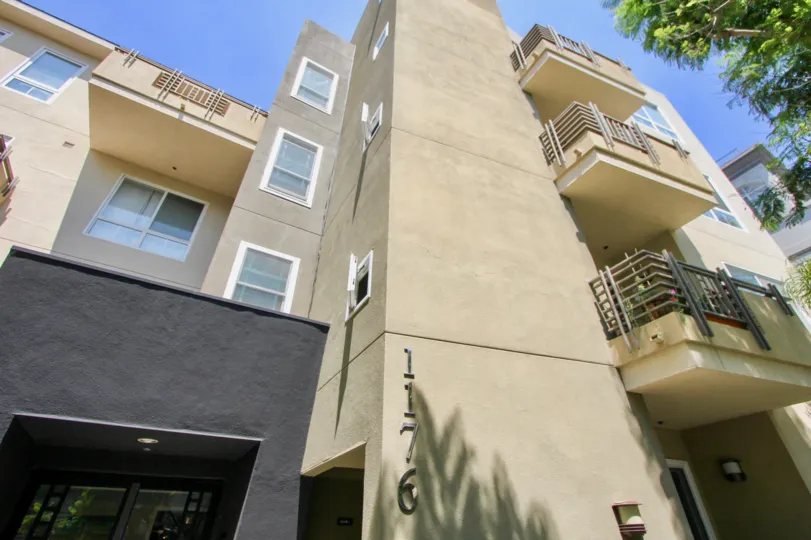 Outside view of a four story apartment building with balconies numbered 1176.