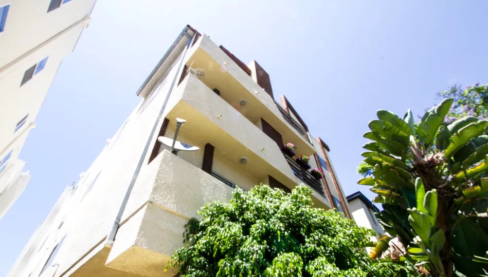 Stucco wrapped balconies extending from the front of White Palace condos