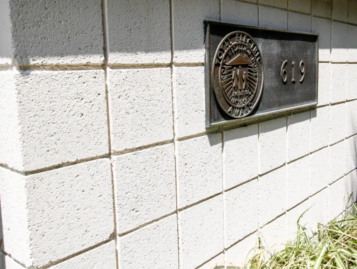 The address plaque on the building at 619 E Olive Ave