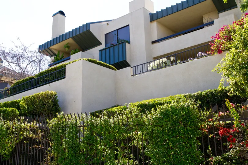 The grounds and balconies of the condos of Century Hill are lushly planted