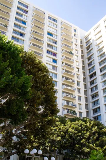 A tall condo tower with balconies extending outward suspended in air