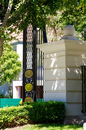 Gold address markers on a metal gate to Le Parc