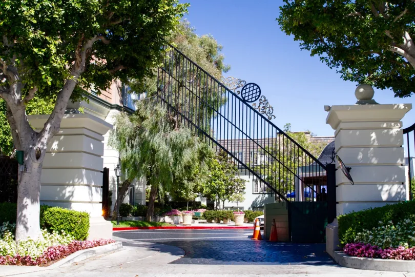 A gate rises to let a car out of the Le Parc community