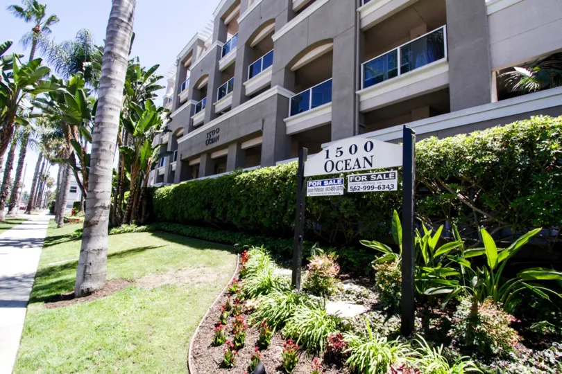 Landscape surrounds 1500 Ocean with a variety of trees, bushes and grass