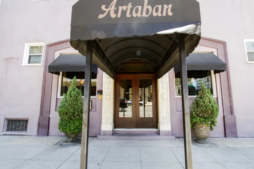 Entry to Artaban two large wood doors with glass insets