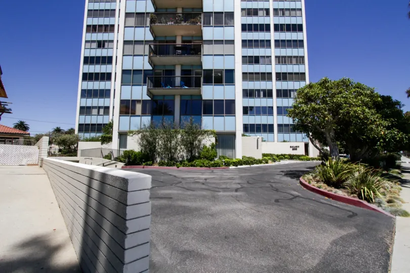 Driveway entrance of Galaxy Tower with the front lobby on one side and garage parking at the other