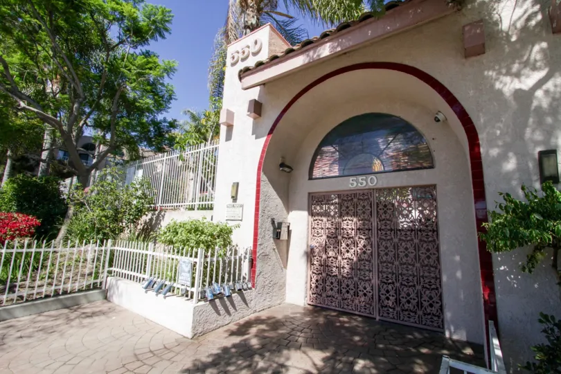 The entrance to Genesis is a stucco wall with arch and metal doors