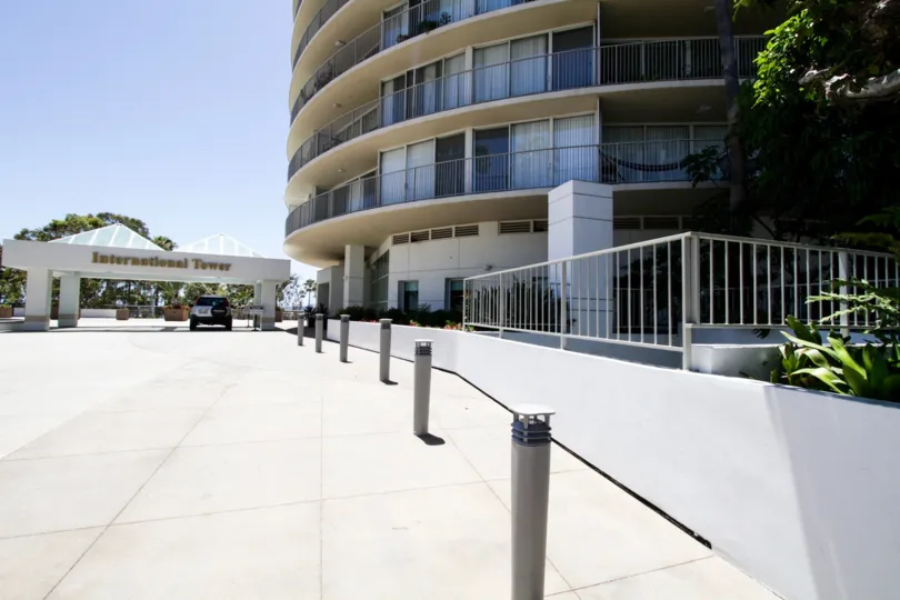 Pillars with lights create a walkway to the entrance of International Tower