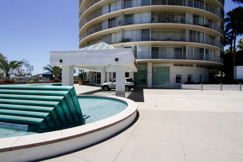 A large fountain sits across from the entrance to International Tower