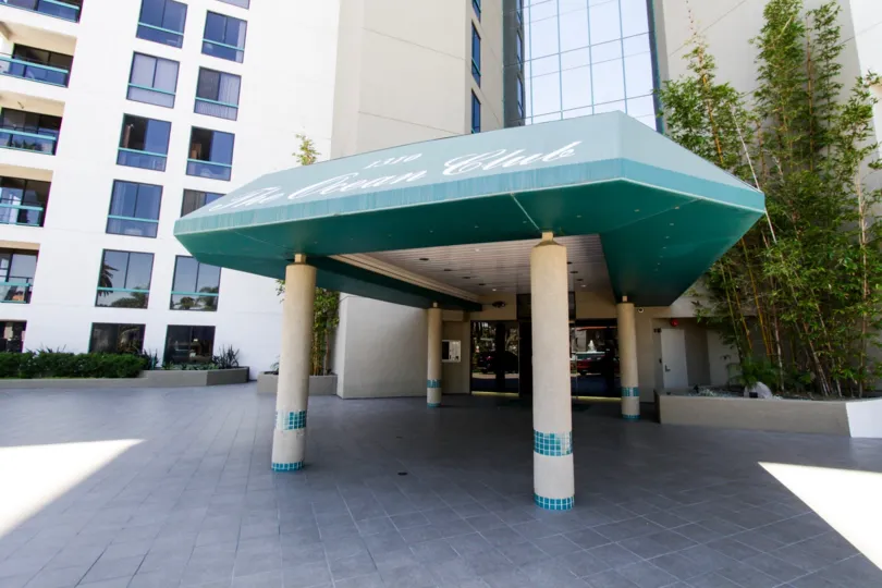 A covered canopy shades residents to the lobby of Ocean Club