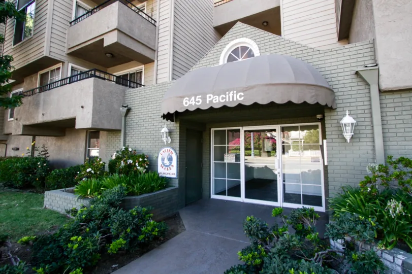 A covered canopy leads to the front door of Pacific Shores