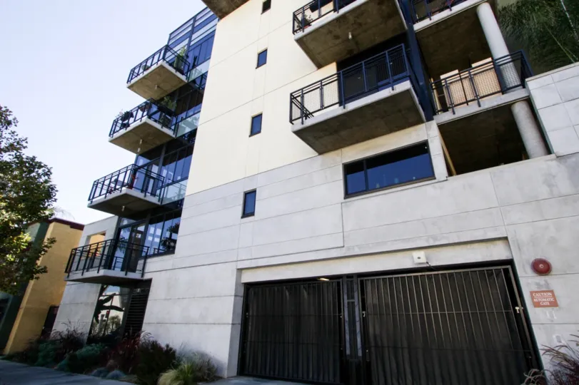 Glass walls lead to corner balconies at Temple Lofts