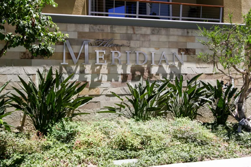The Meridian marquee on a stone wall in front of the building