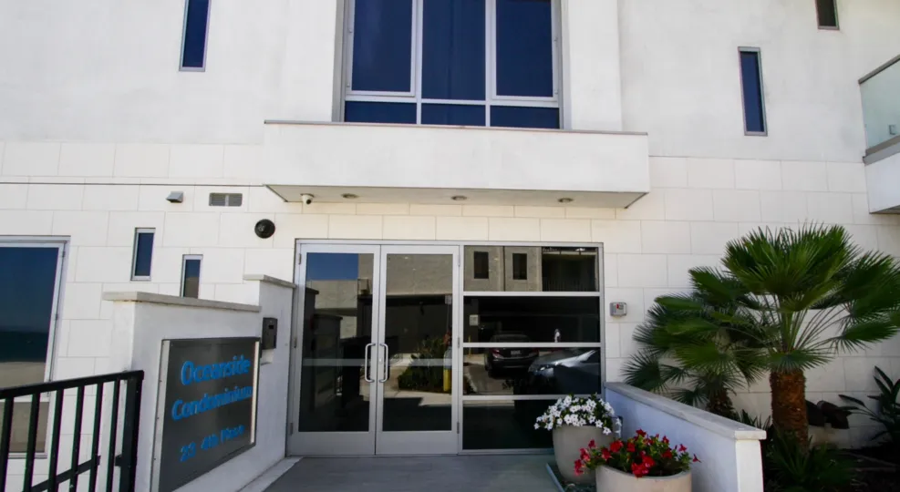 Glass doors lead to the lobby of The Oceanside