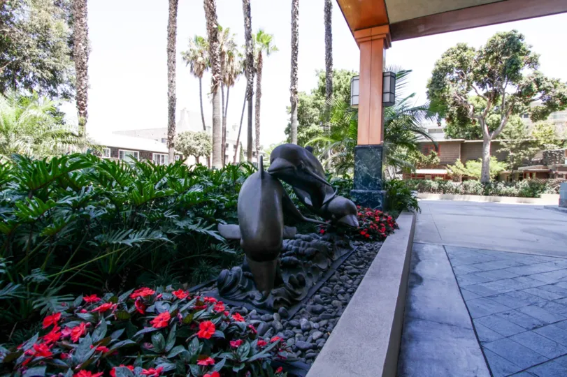 A statue of dolphins at the entrance to The Pacific