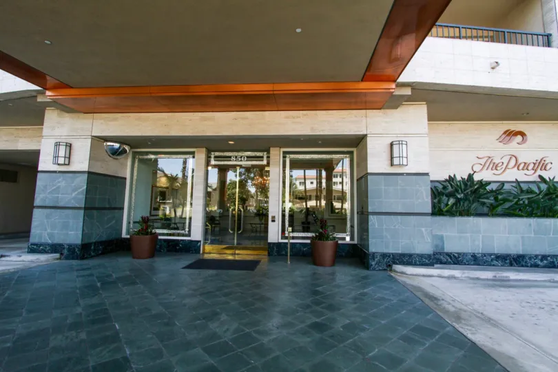 Glass doors with gold trim at the entrance to The Pacific