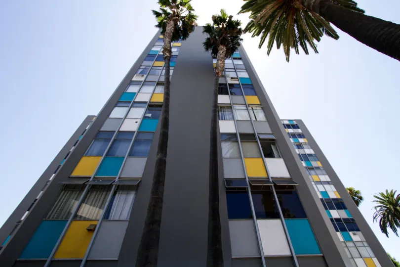 Palm trees rise with The Royal Palms building