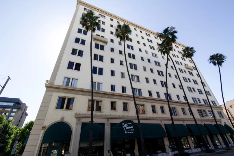 Palm trees line the sidewalk in front of The Wilmore