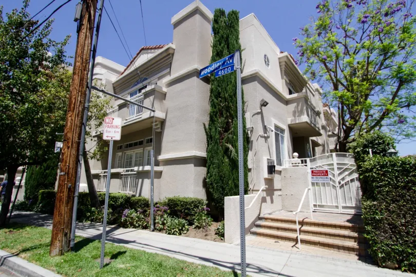 The view of the side entrance to 4630 Woodley Ave complete with landscaping