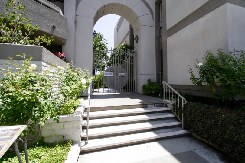 The gated entrance leading to the buildings within the Encino Spa East property